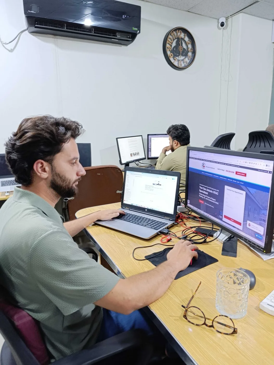 A Vital Web Solution team member designing a client website at his desk