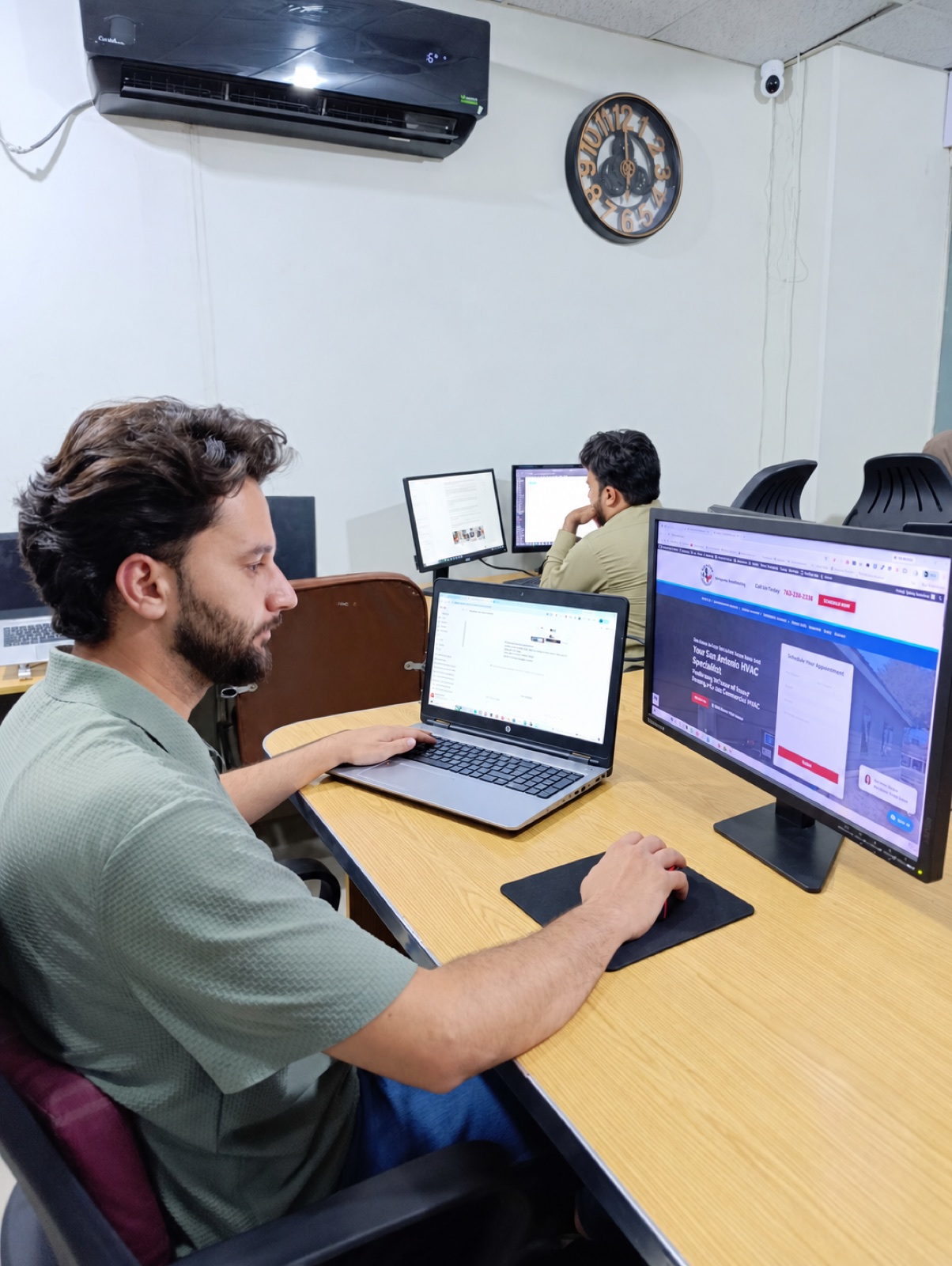 Developer working at a tidy workstation in the Vital Web Solution office